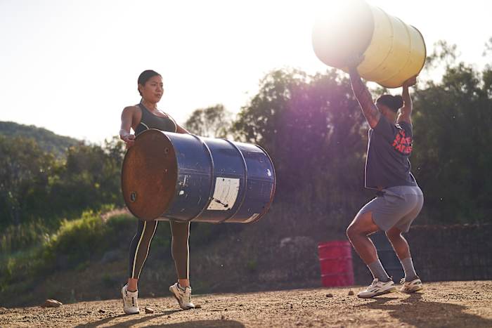 Athletes training outdoors in Reebok apparel.